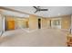 Neutral living room featuring tile floors, mirrored walls, and a ceiling fan at 614 Norton St, Longboat Key, FL 34228