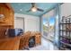 Office area features a wooden desk with balcony access, storage and closet with ceiling fan at 614 Norton St, Longboat Key, FL 34228