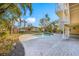 Backyard pool with patio and spiral staircase, surrounded by lush tropical landscaping at 614 Norton St, Longboat Key, FL 34228