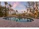 Backyard pool with outdoor seating, canal views, and lush landscaping at 614 Norton St, Longboat Key, FL 34228