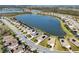 Aerial view of a community with lakefront homes and solar panels at 6534 Clairborne Ln, Lakewood Ranch, FL 34211