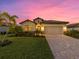 One-story home with a landscaped lawn and paved driveway at 6534 Clairborne Ln, Lakewood Ranch, FL 34211