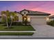 One-story home with tile roof, two-car garage, and manicured lawn at 6534 Clairborne Ln, Lakewood Ranch, FL 34211