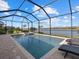 Enclosed pool and spa with lake view; relaxing patio furniture at 6534 Clairborne Ln, Lakewood Ranch, FL 34211