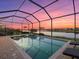 Enclosed pool and spa at sunset; stunning lake view at 6534 Clairborne Ln, Lakewood Ranch, FL 34211