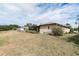 Home's exterior view, showcasing backyard and screened patio at 6950 42Nd E Ct, Sarasota, FL 34243