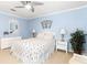 Bright bedroom with white dresser and palm tree bedding at 6950 42Nd E Ct, Sarasota, FL 34243