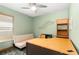 Home office with a desk, sofa bed, and built-in shelving at 6950 42Nd E Ct, Sarasota, FL 34243