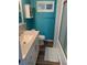 Bright teal bathroom with white vanity, toilet and shower at 712 51St Avenue W Ter, Bradenton, FL 34207