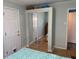 Bedroom with mirrored closet doors and wood floors at 712 51St Avenue W Ter, Bradenton, FL 34207