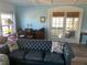 Living room with a blue leather sofa and french doors leading to a screened porch at 712 51St Avenue W Ter, Bradenton, FL 34207