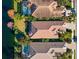 Aerial view of three homes with tile roofs and pools near canal at 7121 Orchid Island Pl, Bradenton, FL 34202