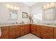 Double vanity bathroom with granite countertops and wood cabinets at 7121 Orchid Island Pl, Bradenton, FL 34202