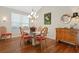 Elegant dining room with hardwood floors and a glass-top table at 7121 Orchid Island Pl, Bradenton, FL 34202