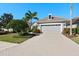 Attached garage with paved driveway and mature landscaping at 7121 Orchid Island Pl, Bradenton, FL 34202