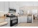 Modern kitchen with stainless steel appliances and white cabinets at 7121 Orchid Island Pl, Bradenton, FL 34202