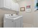 Laundry room with white cabinets and LG washer and dryer at 7121 Orchid Island Pl, Bradenton, FL 34202