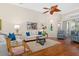 Living room with hardwood floors, comfortable seating, and large windows at 7121 Orchid Island Pl, Bradenton, FL 34202