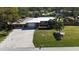 Aerial view of a single-story house with a driveway and a neatly landscaped front yard at 7307 9Th Nw Ave, Bradenton, FL 34209