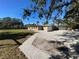 Home's backyard with a paved walkway and gravel at 7307 9Th Nw Ave, Bradenton, FL 34209