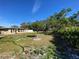 Large grassy backyard with mature trees and shed at 7307 9Th Nw Ave, Bradenton, FL 34209