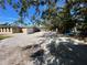 Backyard view with gravel driveway and partial fence at 7307 9Th Nw Ave, Bradenton, FL 34209