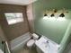 Clean bathroom with tub, toilet, and vanity with light fixtures at 7307 9Th Nw Ave, Bradenton, FL 34209