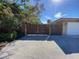 Driveway entrance with wooden gates and gravel at 7307 9Th Nw Ave, Bradenton, FL 34209