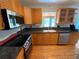 Kitchen with wood cabinets, granite counters, and stainless steel appliances at 7307 9Th Nw Ave, Bradenton, FL 34209