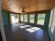 Bright sunroom with tile flooring and wood ceiling, featuring multiple windows and backyard access at 7307 9Th Nw Ave, Bradenton, FL 34209