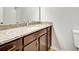 Bathroom with granite countertop and dark wood cabinets at 7560 Plantation Cir, Bradenton, FL 34201