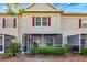 Townhome with a screened patio and manicured hedges at 7560 Plantation Cir, Bradenton, FL 34201