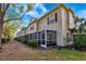 Tan siding townhome with screened patio and landscaping at 7560 Plantation Cir, Bradenton, FL 34201