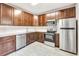 Updated kitchen featuring granite countertops and wood cabinets at 7560 Plantation Cir, Bradenton, FL 34201