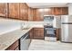 Modern kitchen with dark wood cabinets and stainless steel appliances at 7560 Plantation Cir, Bradenton, FL 34201