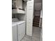 Stackable washer and dryer in laundry room with built-in shelving at 7560 Plantation Cir, Bradenton, FL 34201