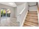 Wood stairs leading to the second floor with access to a screened porch at 7560 Plantation Cir, Bradenton, FL 34201