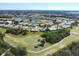 Aerial view of community with golf course and numerous houses at 8240 Parkside Dr, Englewood, FL 34224