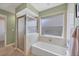 Bathroom with a shower/tub combo and a window at 8240 Parkside Dr, Englewood, FL 34224