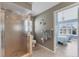 Bathroom with a shower and toilet, and a view of a bedroom at 8240 Parkside Dr, Englewood, FL 34224