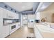 White kitchen cabinets, light blue walls, and tile floor at 8240 Parkside Dr, Englewood, FL 34224