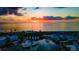 Stunning sunset view over marina with boats and waterfront homes at 8240 Parkside Dr, Englewood, FL 34224