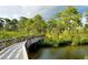 Scenic nature trail with wooden boardwalk over water at 8240 Parkside Dr, Englewood, FL 34224