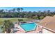 Community pool with ample deck space and lounge chairs at 8240 Parkside Dr, Englewood, FL 34224