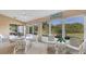 Sunroom with white wicker furniture and view of backyard at 8240 Parkside Dr, Englewood, FL 34224