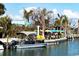 Outdoor waterfront restaurant with patio seating under umbrellas and boat rentals at 8240 Parkside Dr, Englewood, FL 34224