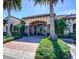 Inviting clubhouse entrance with lush landscaping and a welcoming facade, enhancing community appeal at 8279 Varenna Dr, Sarasota, FL 34231