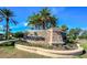 Stone community entrance sign with lush tropical landscaping at the Esplanade by Siesta Key at 8279 Varenna Dr, Sarasota, FL 34231