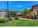 Landscaped front yard with brick walkway leading to a well-maintained home and manicured green lawn at 8279 Varenna Dr, Sarasota, FL 34231