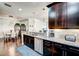 Open kitchen design featuring dark wood cabinets, granite countertops, and stainless steel appliances at 8279 Varenna Dr, Sarasota, FL 34231